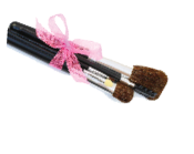 Make-up brushes with pink bow isolated over white