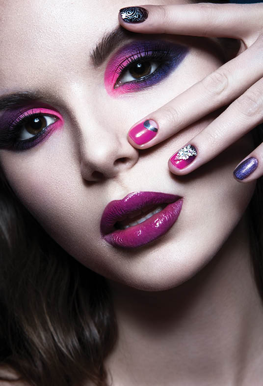 Beautiful girl with bright creative fashion makeup and colorful nail polish. Art beauty design. Photos shot in studio