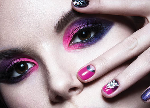 Beautiful girl with bright creative fashion makeup and colorful nail polish. Art beauty design. Photos shot in studio